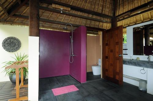 a bathroom with a shower and a purple door at Koh Yao Sunrise Villa in Ko Yao Noi
