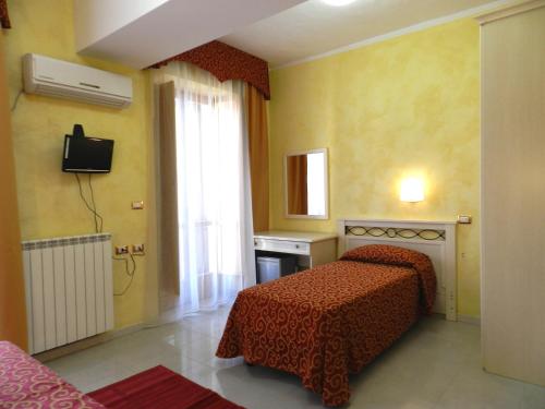 a hotel room with a bed and a window at Hotel Air Palace Lingotto in Turin