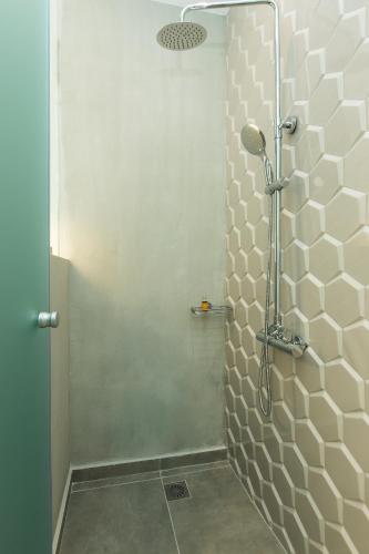 a shower with a glass door in a bathroom at Ark 68 City Rooms in Rethymno Town