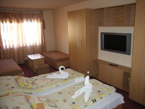 Ένα ή περισσότερα κρεβάτια σε δωμάτιο στο Pálma Apartmanház Harkány