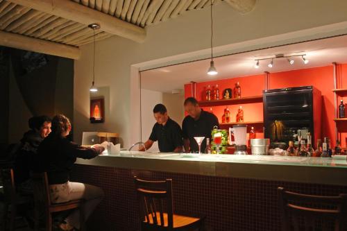 a group of people standing at a bar at Hotel Itapemar - Ilhabela in Ilhabela