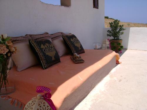 a bed with pillows and a bow on it at Papadiokampos Maissonete in Roússa Límni