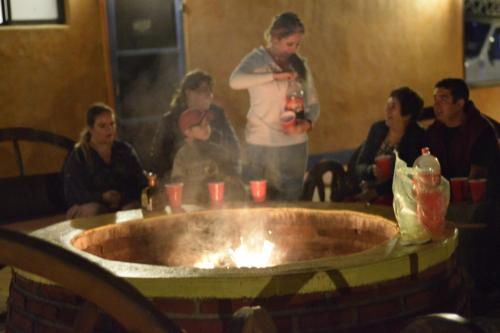 a group of people sitting around a large tub at Villa Mexicana Creel Mountain Lodge in Creel