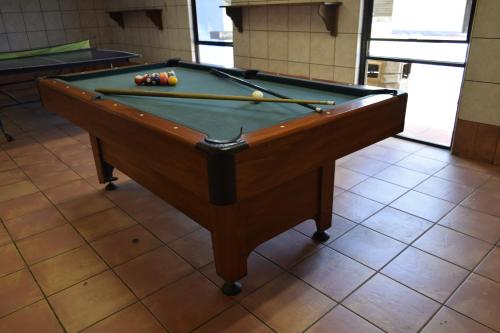 a pool table with balls on top of it at Villa Mexicana Creel Mountain Lodge in Creel