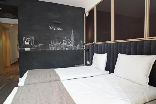 two beds in a room with a black wall at Vila Europa in Struga