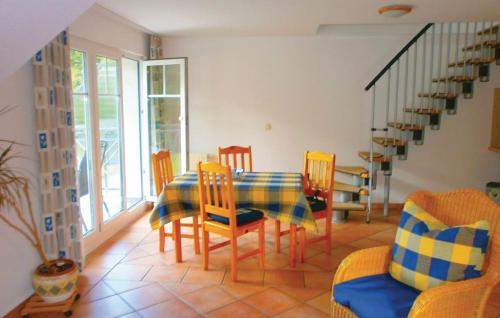 a dining room with a table and chairs and a staircase at Ferienwohnung Möwe in Graal-Müritz