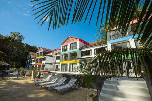 a row of chairs in front of a building at Quality Hotel Oceans Tutukaka in Tutukaka