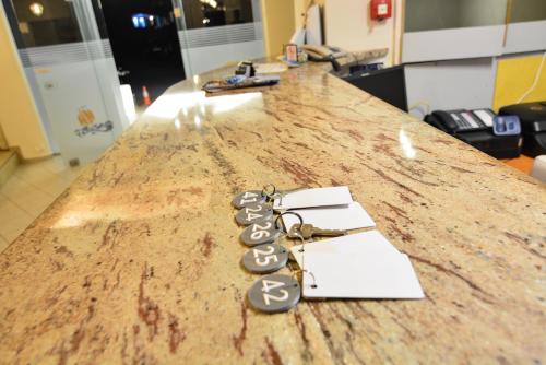 a counter top with a bunch of keys on it at Marzi Boutique Hotel in Nerátza