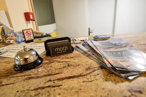 a counter top with a radio and magazines on it at Marzi Boutique Hotel in Nerátza