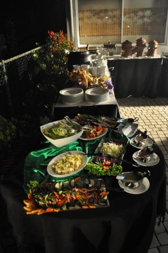 a buffet line with plates of food on a table at Amaara Sky Hotel Kandy in Kandy