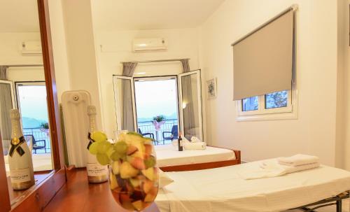 a room with a table with a vase of fruit on it at Marzi Boutique Hotel in Nerátza