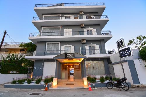 a tall building with a entrance to a store at Marzi Boutique Hotel in Nerátza