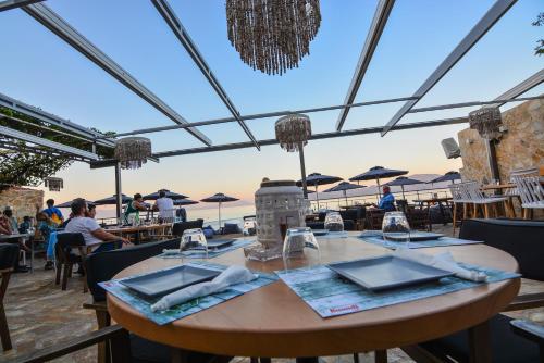 a table at a restaurant with a view of the ocean at Marzi Boutique Hotel in Nerátza