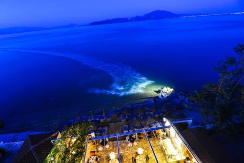 an aerial view of the ocean at night at Marzi Boutique Hotel in Nerátza