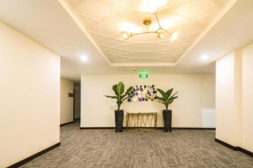 a hallway with two plants in a room at Lake View Hotel in Quy Nhon