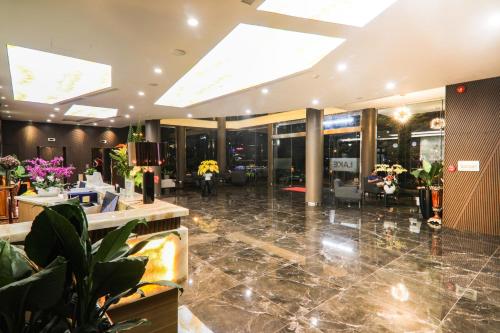 a lobby of a building with a lot of plants at Lake View Hotel in Quy Nhon