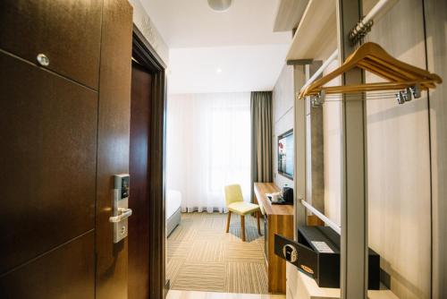 a hotel room with a door and a desk at The Smith House in Pantai Cenang