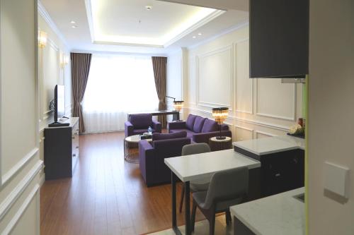 a living room with purple chairs and a couch at Dai Viet Hotel in Thanh Hóa