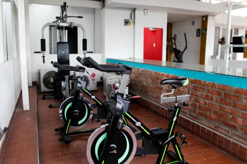 two bikes parked next to a bar in a gym at Hotel Brisas De Calima in Cali