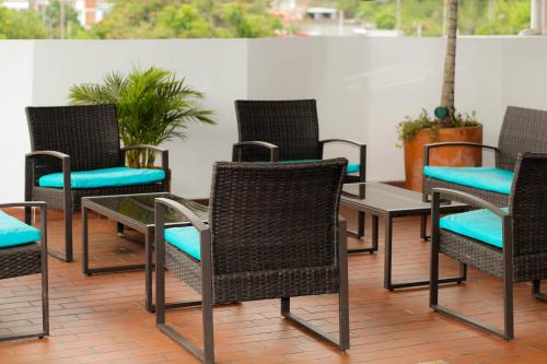 a group of chairs and tables on a patio at Hotel Brisas De Calima in Cali