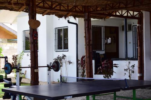 a ping pong table in front of a house at the beachhouse in Dalaguete