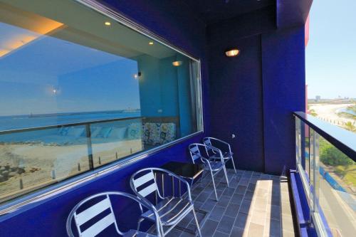a balcony with chairs and a view of the ocean at Two Home Inn in Hualien City