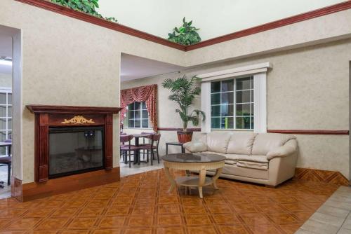 a living room with a couch and a fireplace at Days Inn by Wyndham Norton in Norton