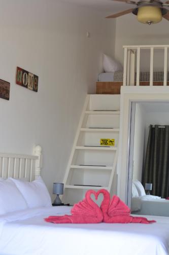 a bedroom with a bed with a heart towel on it at the beachhouse in Dalaguete