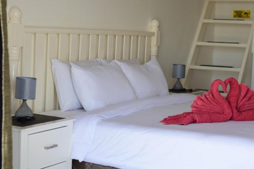 a bedroom with a bed with a red towel on it at the beachhouse in Dalaguete