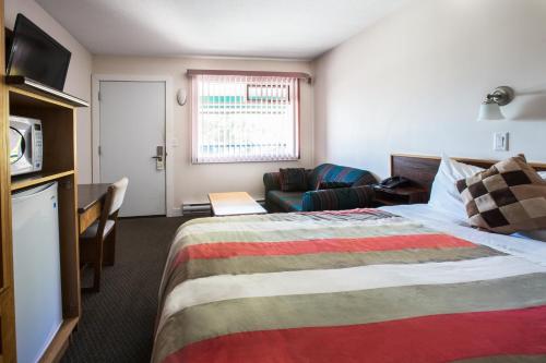 a hotel room with a bed and a couch at Grandview Motel in Kamloops