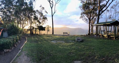 a park with a bench and a view of the mountains at Valley View Luxury Retreat in Vacy