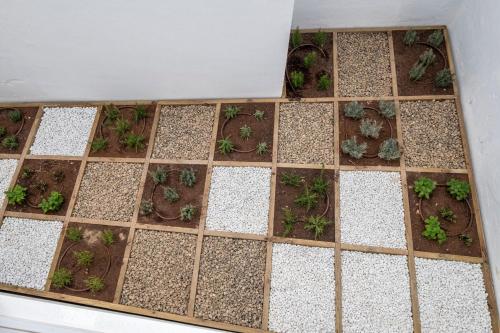 a wooden chess board with plants on it at Divina Suites Hotel Boutique - Adults only in Ciutadella