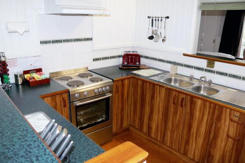 a kitchen with a stove and a sink at Valley View Luxury Retreat in Vacy