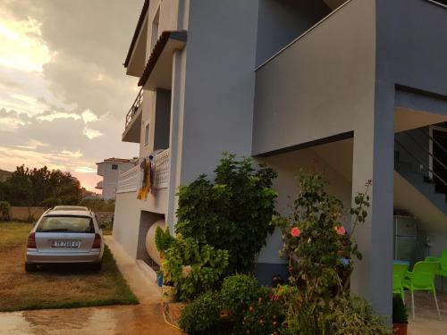 a car parked next to a building at Vila DINI Ksamil in Ksamil