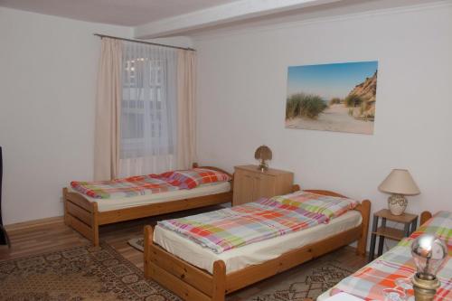 a bedroom with three beds and a window at Gasthaus zum Adler in Baden-Baden