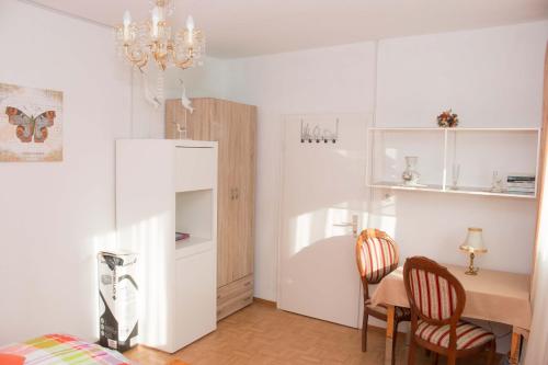 a kitchen with a table and chairs and a dining room at Gasthaus zum Adler in Baden-Baden