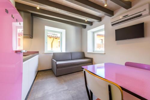a living room with a table and a couch at Casa Kaki in Malcesine