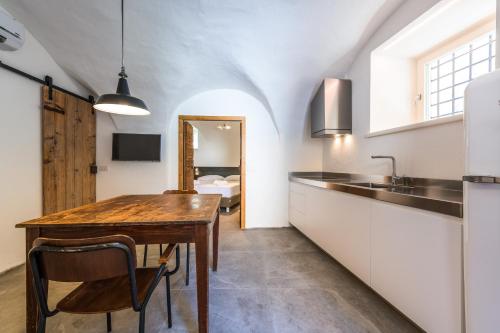 a kitchen with a wooden table and a sink at Casa Kaki in Malcesine