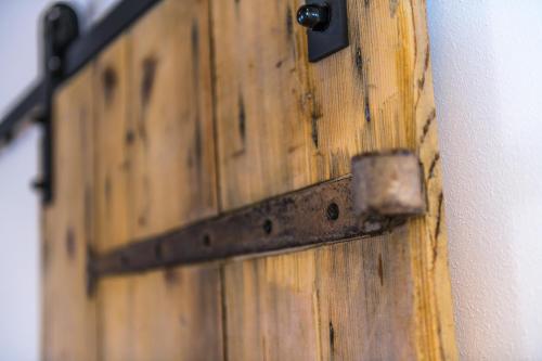 a wooden door with a metal latch on a wall at Casa Kaki in Malcesine