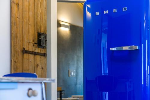 a blue shower in a room with blue chairs at Casa Kaki in Malcesine