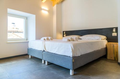a bedroom with a large bed with two pillows on it at Casa Kaki in Malcesine