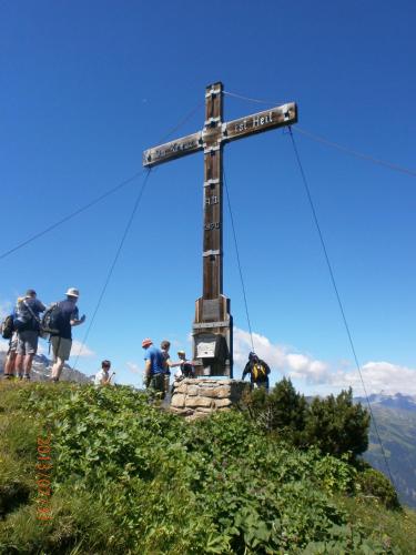 a cross on the top of a mountain at Pension Backstuba in Partenen