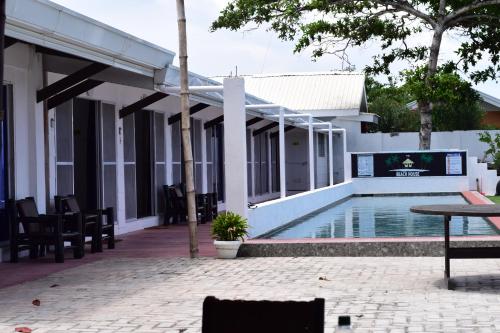 a villa with a swimming pool and a patio at the beachhouse in Dalaguete