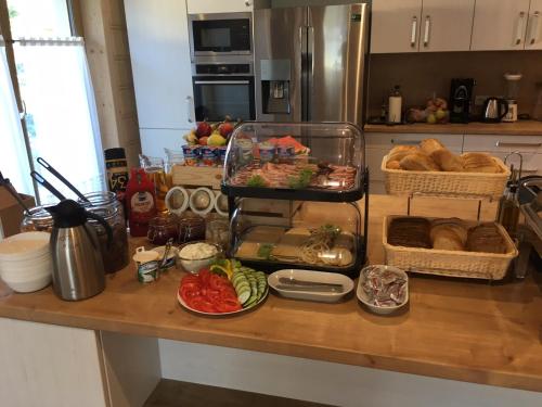 a kitchen counter with bread and baskets of food at Stachelisko - domki i pokoje in Chochołów