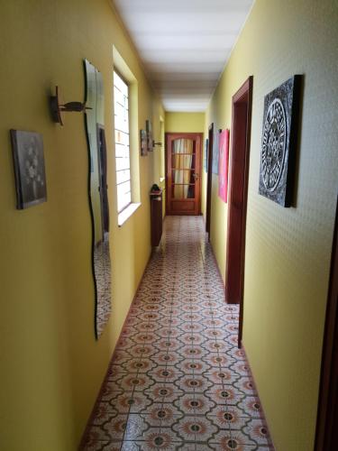 a hallway with yellow walls and a tile floor at les gites de l'océan indien in Batzendorf