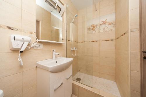 a bathroom with a sink and a shower at Villa "White Pearl" Zatoka in Zatoka