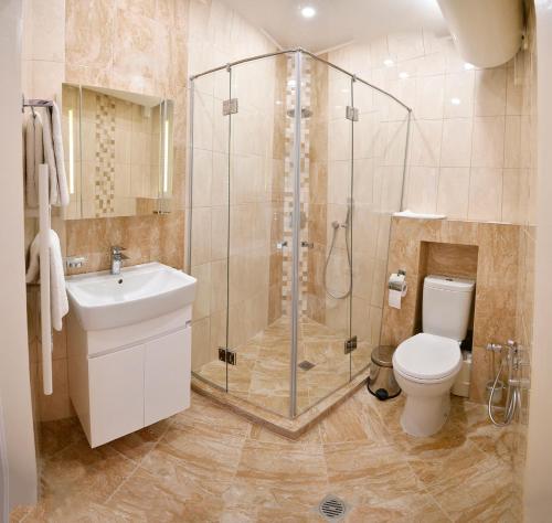 a bathroom with a shower and a toilet and a sink at Shipka 1 in Varna City