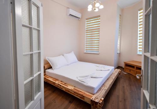 a room with a bed on a wooden platform at Shipka 1 in Varna City