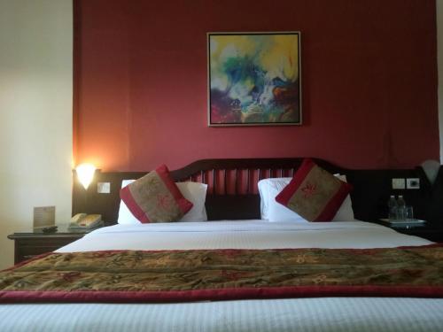 Postel nebo postele na pokoji v ubytování Ramee Guestline Hotel Bangalore
