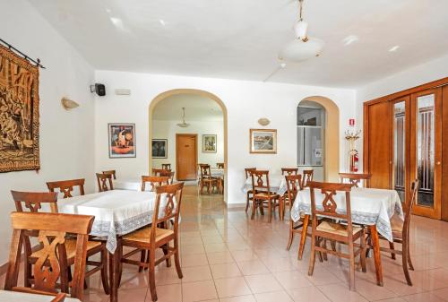 a dining room with two tables and chairs at Albergo Rondò in Acqui Terme